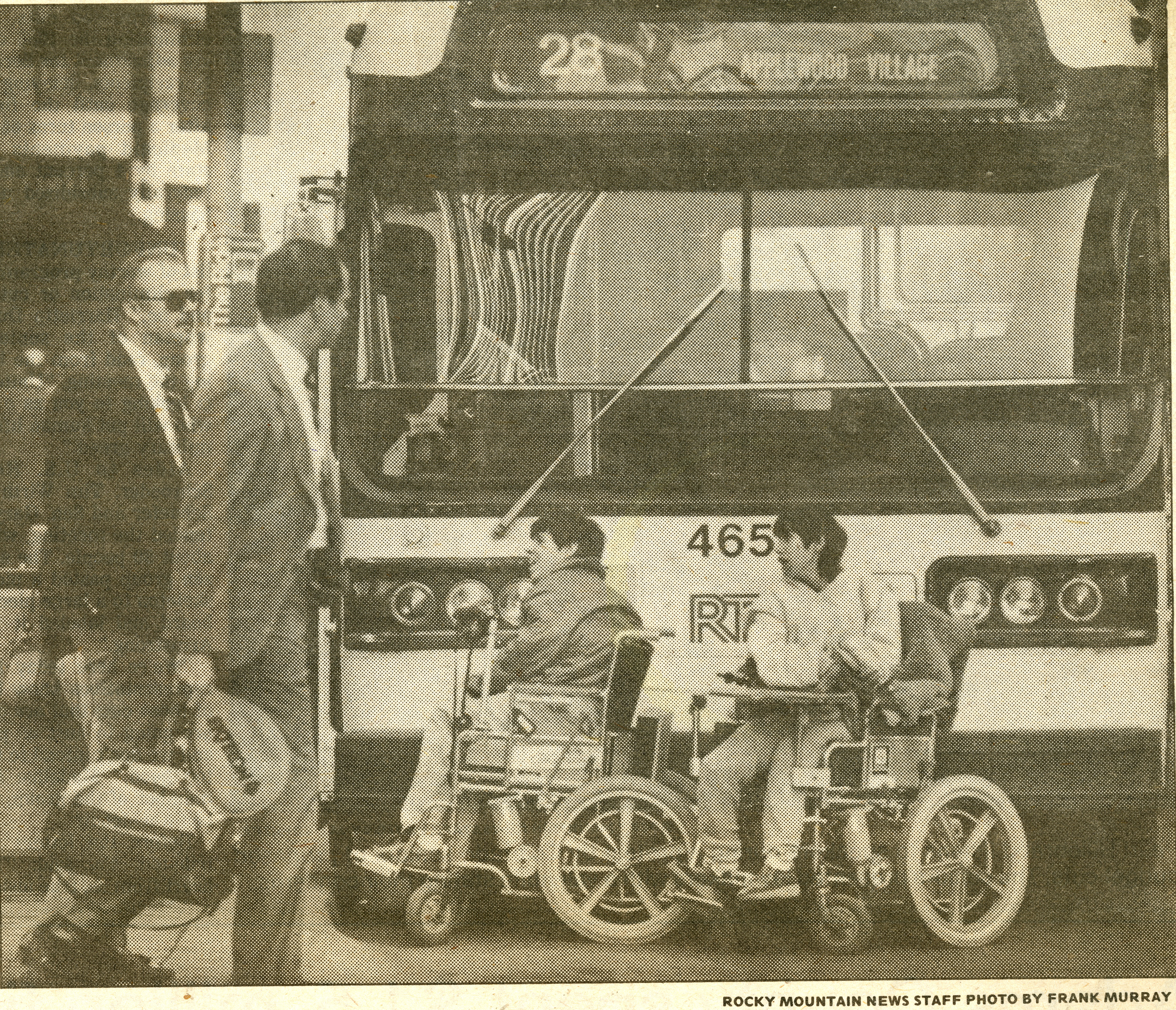 Two men in wheelchairs block the path of an RTD bus.